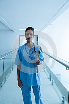 Female surgeon looking at camera in the corridor of hospital