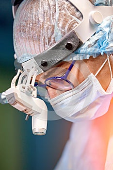 Female surgeon in operation room with reflection in glasses