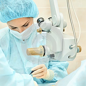 Female surgeon performing microsurgery with precision in operating room