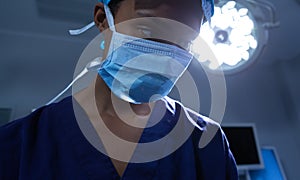 Female surgeon performing operation in operating room at hospital