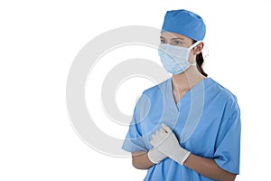 Female surgeon standing against white background