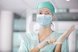 female surgeon in uniform getting ready for medical procedure surgery