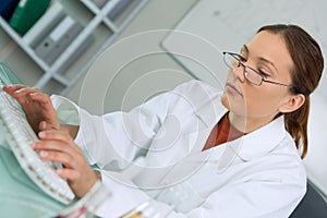 female surgeon using laptop against blue data