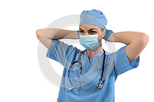 Female surgeon wearing face mask against white background