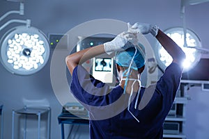 Female surgeon wearing surgical mask on in operating room at hospital