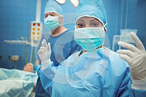Female surgeon wearing surgical mask in operation theater