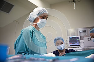 Female Surgical Team Working On Patient In Hospital Operating Theatre