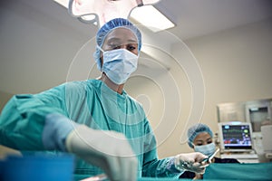 Female Surgical Team Working On Patient In Hospital Operating Theatre