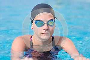 Female swimmer in blue water swimming pool. Sport woman.