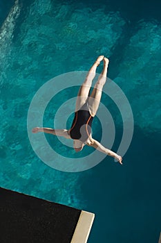 Female Swimmer Diving In Midair photo