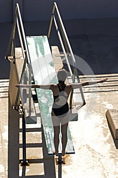 Female Swimmer Diving From The Springboard photo