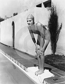 Female swimmer at edge of pool