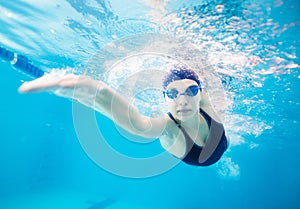 Female swimmer gushing through water in pool