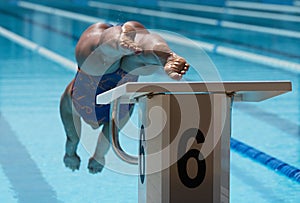 Female swimmer jumps off starting block