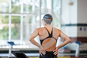 Female swimmer smiling and focusing before the race start