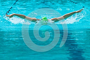 Female swimmer working on her butterfly stroke swim at a local