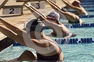 Female Swimmers On Starting Blocks