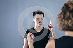 Female taekwondo instructor conducts personal training session for young woman at gym. Girl mastering new taekwondo moves during