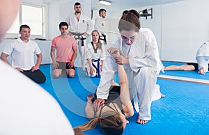 Female taekwondo instructor demonstrates receptions