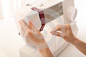 Female tailor threading sewing machine