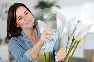 female taking care plants at home