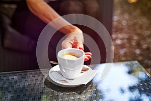 Female taking cup with hot coffee