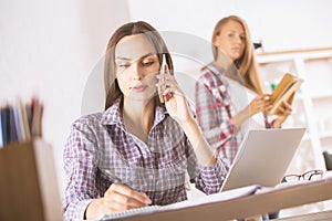 Female talking on phone in office