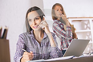 Female talking on phone in office