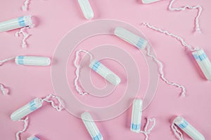 Female tampons on a pink background. Hygienic white tampon for women. Cotton swab