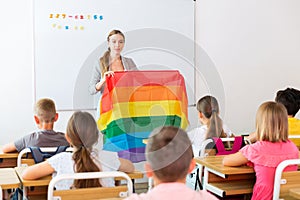 Female teacher discussing with preteen children about LGBT