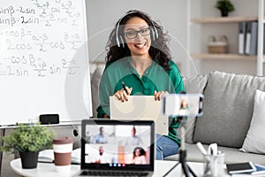 Female teacher giving online lecture to students recording video