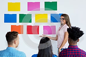 Female teacher with latin and caucasian and african american students