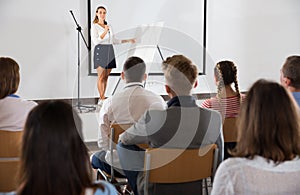 Female teacher lecturing to students