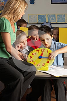 Female Teacher In Primary School Teaching Children