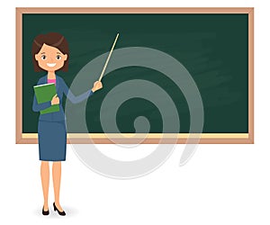 Female teacher standing near of blank school blackboard