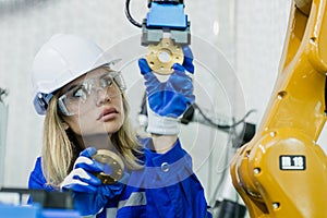 Female technician engineer robotics working at industrial modern factory. woman working at factory innovation automation robot.