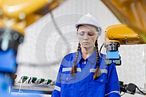 Female technician engineer robotics working at industrial modern factory. woman working at factory innovation automation robot.