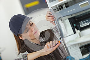 Female technician fixing printer