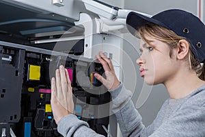 Female technician fixing printer