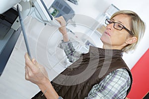 female technician fixing printer