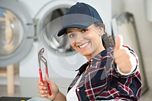 female technician fixing washing machine