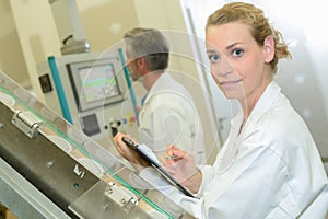Female technician holding clipboard