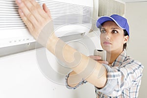 female technician operating air conditioning controls