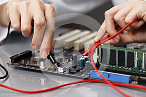 female technician repairing computer motherboard. High quality photo
