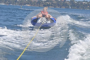 Female teen girl tubing on the river