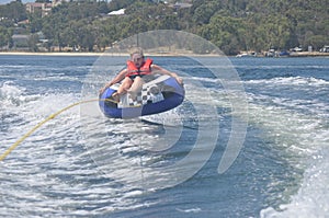 Female teen girl tubing on the river