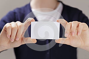 Female teen hands holding business card