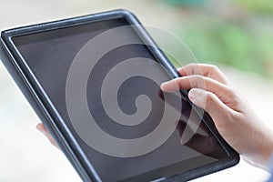 Female teen hands using tablet with black screen