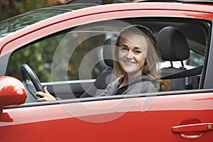 Female Teenage Driver Looking Out Of Car Window