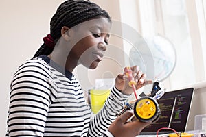 Female Teenage Pupil Building Robot Car In Science Lesson